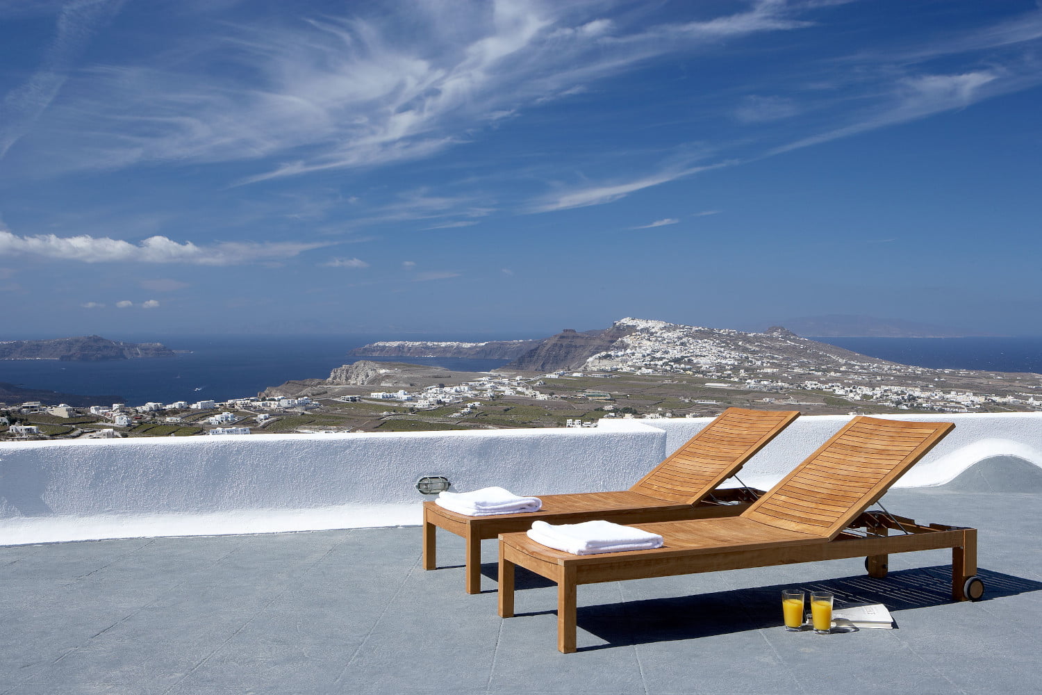 private terrace with sunbeds offering breathtaking views of Santorini Villa Lucia Pyrgos Santorini Greece