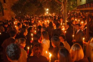 People gathered outside a Greek Orthdox Church holding candles on Great Saturday as part of the celebrations for Easter in Greece