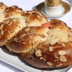 pictured here is a tsoureki, a greek sweet bread, next to a cup of Greek coffee, as part of the celebration of Easter in Greece