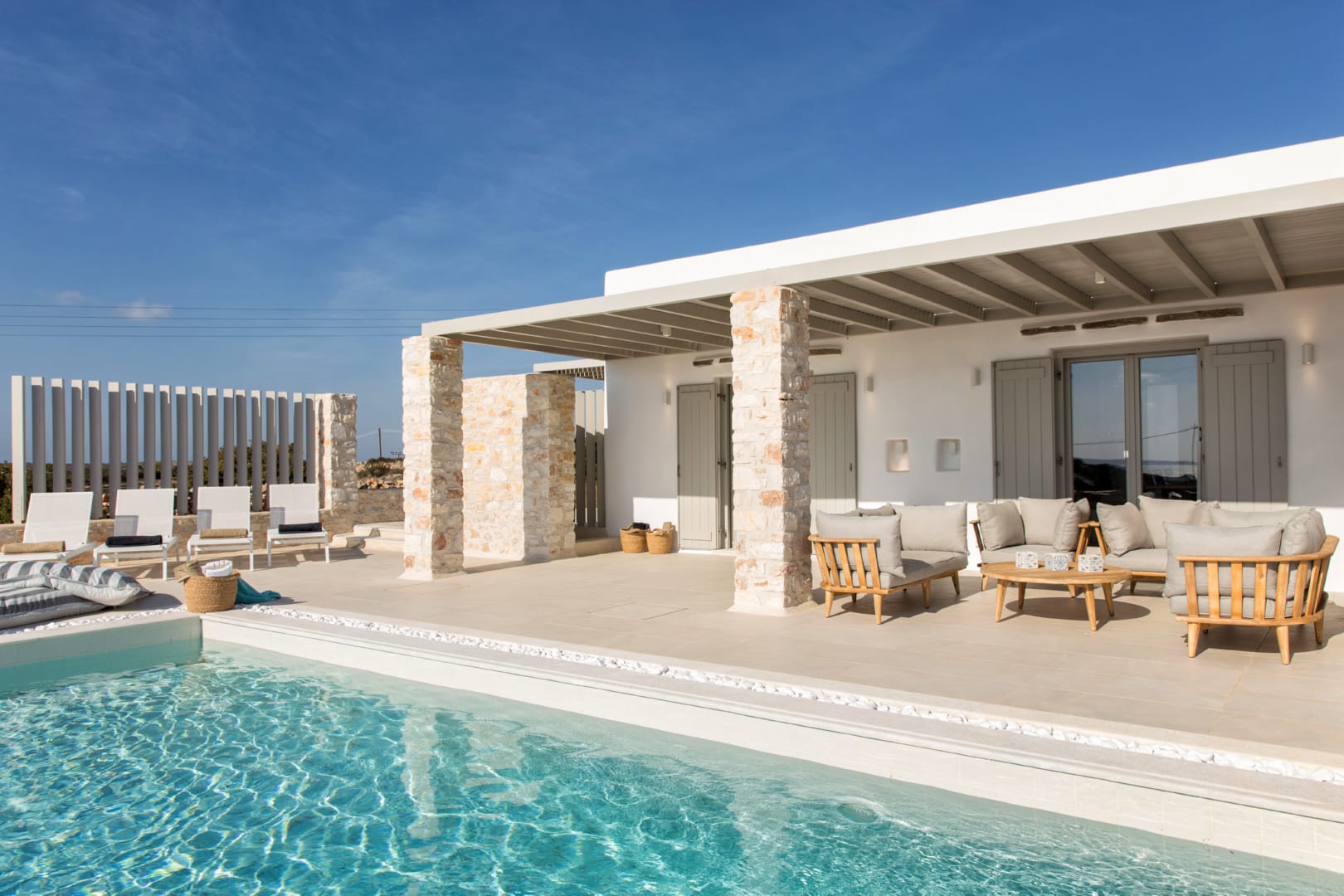 the pool and the facade of the luxurious Paros Villa Kallia by Rent A Greek Villa