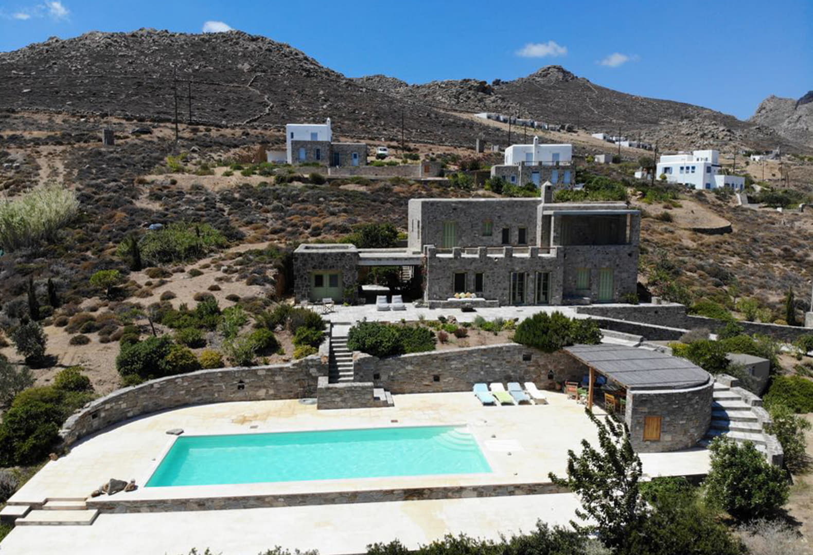 Serifos estate villa Maestrali with stone facade and private pool overlooking the hillside